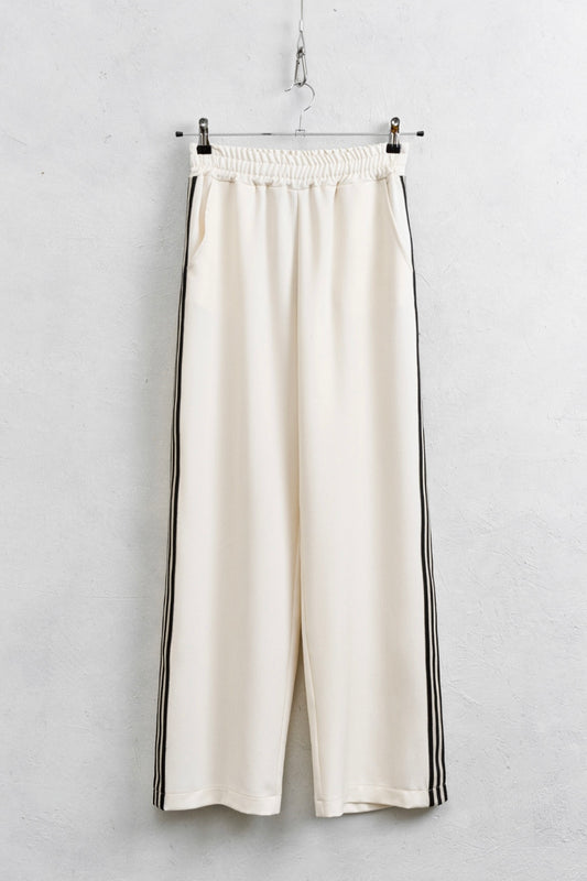 Krémové kalhoty s černými pruhy